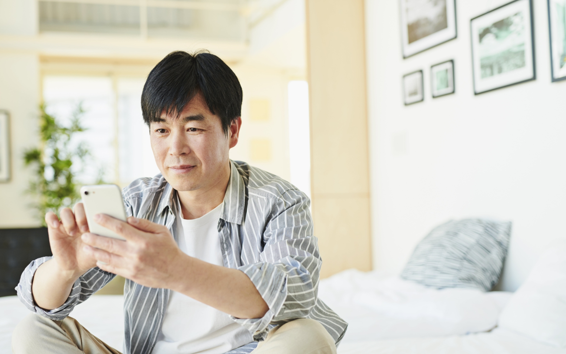 Guest enjoying his hotel room with mobile device