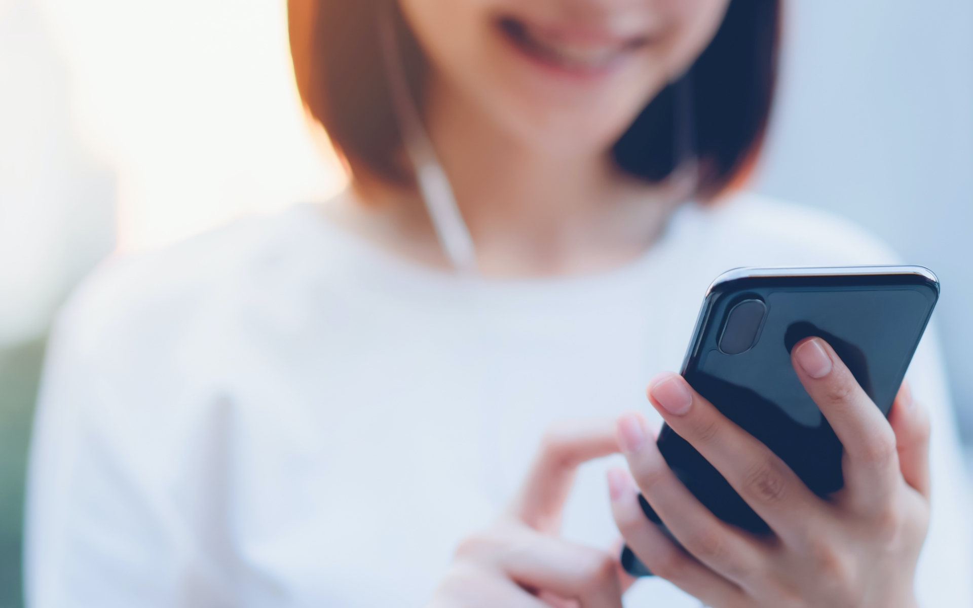 Woman using her mobile device for hotel needs