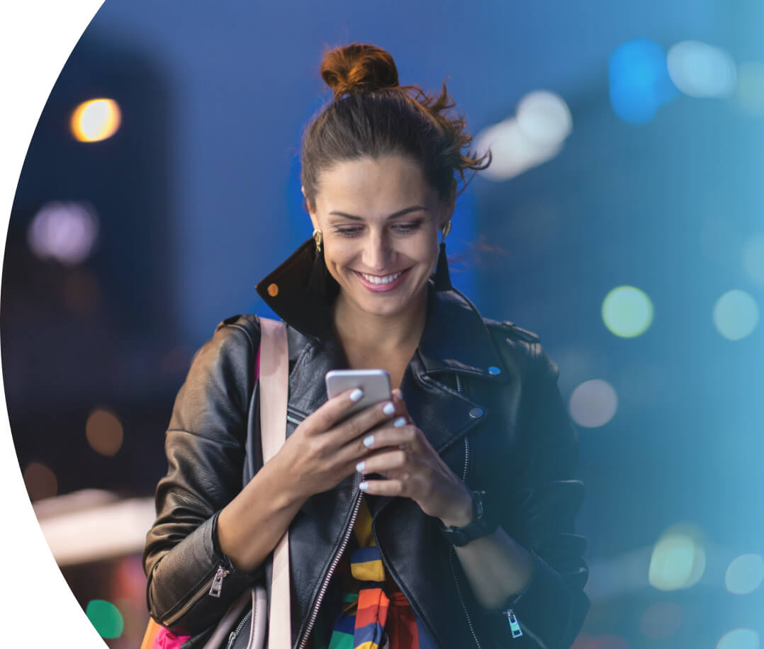 woman smiling looking at phone using mobile check in hotel software