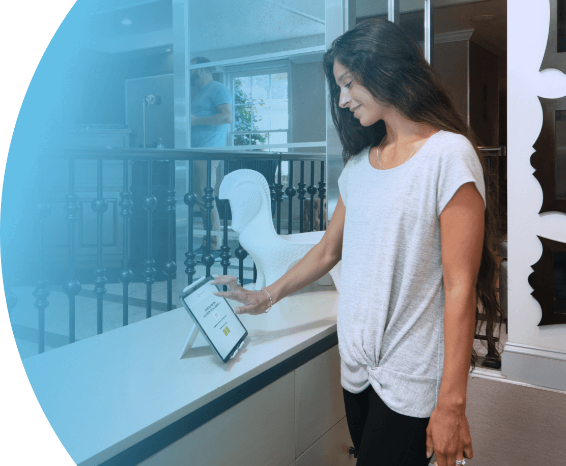 women in the lobby using hotel kiosk to check-in